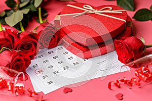 Valentine day. Red hearths and roses on Calendar page. February 14 of Saint Valentines day. Pink background.