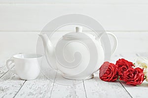 Valentine day romantic breakfast with red roses and teapot. Happy Valentine`s day greeting card. Mothers and women`s day