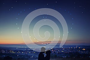 Valentine Day. Silhouette of couple in love against background of night city, stars and horizon. Concept is date on roof