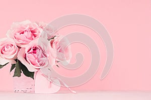 Valentine days decor for home in soft light pastel pink color - romance bouquet of roses and heart with ribbon and bow on wood.