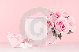 Valentine days decor for home in soft pastel pink - romance bouquet of roses, heart, gift box with perls, ribbon and blank frame.