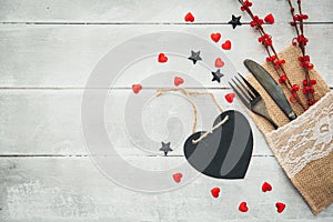 Valentine dinner. Knife and fork on the plate close-up. Valentines