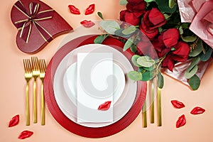 Valentine dinner table setting with red roses, gift and chocolates mockup.