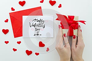 Valentine 14 february hand lettering greeting card. gentle composition for Valentine`s day woman hands holds gift box