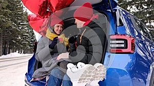 Valentine Gift. Happy Young Couple with Valentine's Day or birthday present. Happy Man giving a gift to his Girlfriend