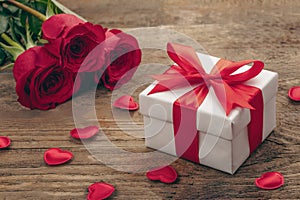 Valentine greeting card background with gift box and fresh burgundy roses