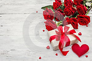 Valentine greeting card background with gift boxes, fresh burgundy roses and assorted hearts