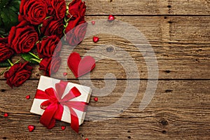 Valentine greeting card background with gift boxes, fresh burgundy roses and assorted hearts