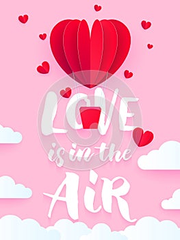 Valentine heart air ballon for Valentine`s day holiday card. Love is in the air text with red hot air baloon paper art greeting c