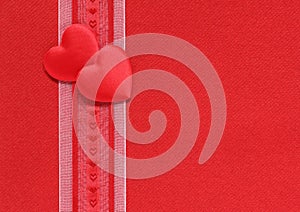 Valentine hearts and ribbon on a red background