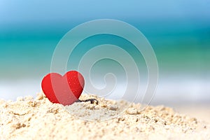 Valentine and Marry Concept. Sigle red hearts couple lovers for married on the sand summer beach,