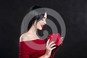 Valentine model Girl portrait. Gorgeous young brunette woman with red gift box. Perfect make up. Valentine` Day brunette lady