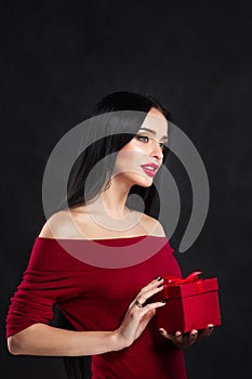 Valentine model Girl portrait. Gorgeous young brunette woman with red gift box. Perfect make up. Valentine` Day brunette lady