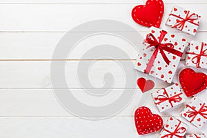 Valentine or other holiday handmade present in paper with red hearts and gifts box in holiday wrapper. Present box gift on white