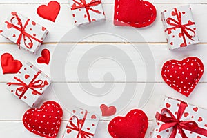 Valentine or other holiday handmade present in paper with red hearts and gifts box in holiday wrapper. Present box gift on white