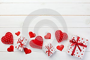 Valentine or other holiday handmade present in paper with red hearts and gifts box in holiday wrapper. Present box gift on white