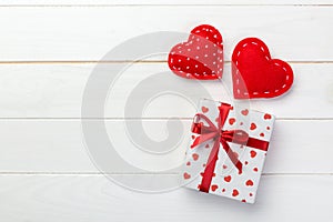 Valentine or other holiday handmade present in paper with red hearts and gifts box in holiday wrapper. Present box gift on white