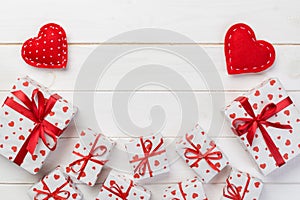 Valentine or other holiday handmade present in paper with red hearts and gifts box in holiday wrapper. Present box gift on white