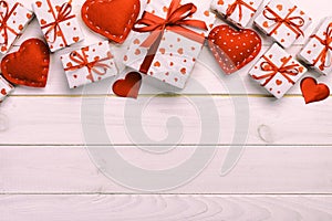 Valentine or other holiday handmade present in paper with red hearts and gifts box in holiday wrapper. Present box gift on white