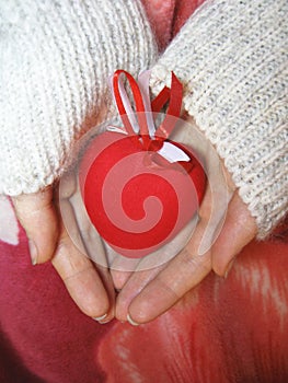 Valentine red heart in woman tender hands