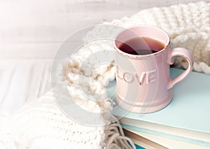 Valentine`s background. Coffee tea mug books knits on wood.