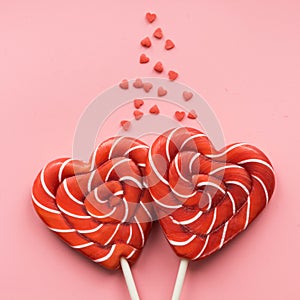 Valentine`s card. Two lollipops candy as heart on pink. Funny concept