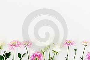 Valentine`s composition with pink flowers and roses white background. Flat lay, top view.