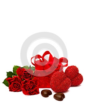 Valentine`s composition with red roses, chocolaty candy, gift box and hearts on white background with space for text
