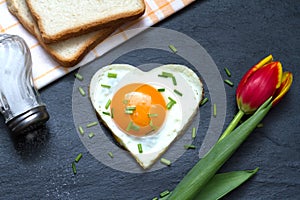 Valentine's Day abstract breakfast with egg heart and tulip