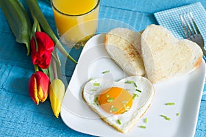 Valentine's Day abstract breakfast with egg heart and tulip