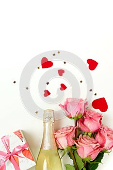 Valentine`s day background . Bouquet of pink roses flowers, gift box and champagne bottle isolated