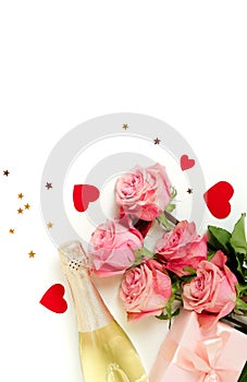 Valentine`s day background . Bouquet of pink roses flowers, gift box and champagne bottle isolated