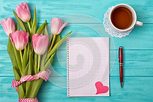 Valentine`s Day background with bouquet of tulips and an empty notebook for romantic entries.