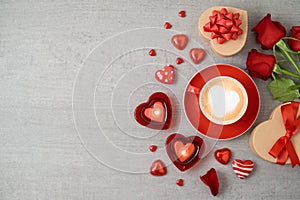 Valentine`s day background with coffee cup, heart shape chocolate, candles, rose flowers and gift boxes