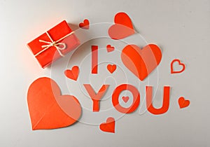 Valentine's Day background. Gifts, candle, confetti, envelope on pastel white background. Valentines day concept.