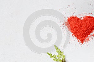 Valentine`s day background. Heart made of red crumbs on a white background. top view. Copy space. Flat lay. Greeting card.