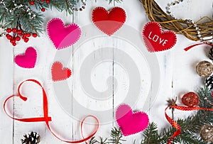 Valentine`s day background, hearts and branches of a Christmas tree on a white tree. place for text. top view