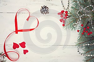 Valentine`s day background, hearts and branches of a Christmas tree on a white tree. place for text. top view