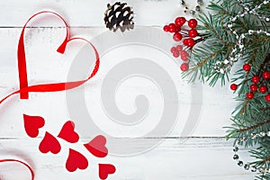 Valentine`s day background, hearts and branches of a Christmas tree on a white tree. place for text. top view