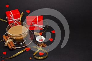 Valentine`s Day on the background of hearts, gifts and candles. On a black background. Top view, straight.