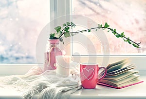 Valentine`s day background,mug on window still.Comfort winter life style