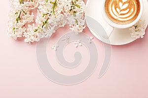 Valentine`s Day background. Pink flowers, plaid, cup of coffee on pink background. Valentines day concept. Flat lay, top view,