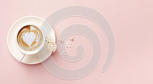 Valentine`s Day background. Pink flowers, plaid, cup of coffee on pink background. Valentines day concept. Flat lay, top view,