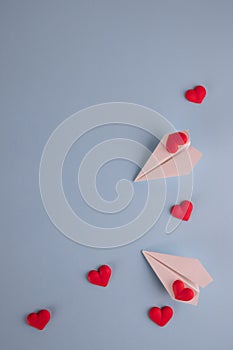 Valentine`s Day background. Red candy  hearts and paper plane on pastel blue background. Valentines day concept. Flat lay,