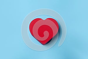 Valentine`s day  background. Red heart on a blue minimal background. Love, romance and heart concept