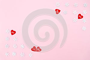 Valentine`s Day background. red hearts and snowflakes on pink background. Valentines day concept. Flat lay, top view, copy space