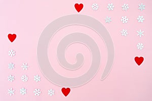 Valentine`s Day background. red hearts and snowflakes on pink background. Valentines day concept. Flat lay, top view, copy space