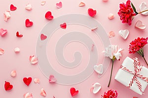 Valentine\'s Day background with red and white hearts and gift box on pink