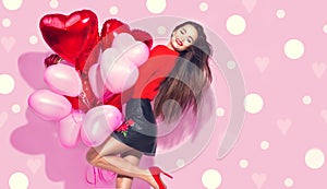 Valentine`s Day. Beauty girl with colorful air balloons having fun