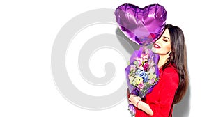 Valentine`s Day. Beauty girl with colorful bouquet of flowers and heart shape air balloon on white background